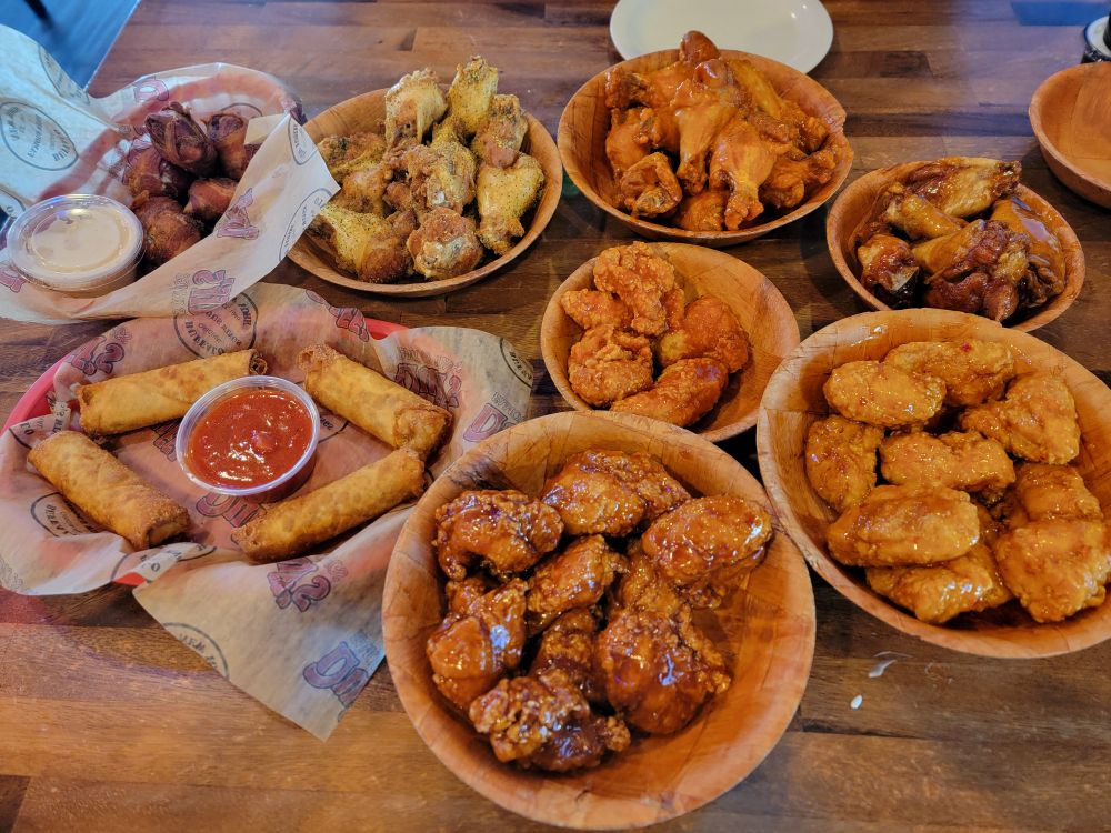 Bowls of various chicken wing flavors, both boneless and bone in.