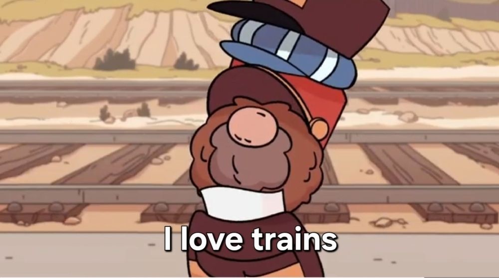 Little hairy guy with lots of train related hats saying 'I love trains'