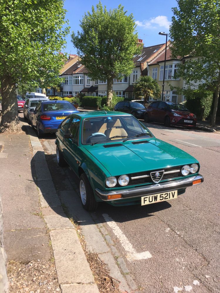 A 70s(?) alfasud a sitting in the London sun, a shade lighter than British racing green