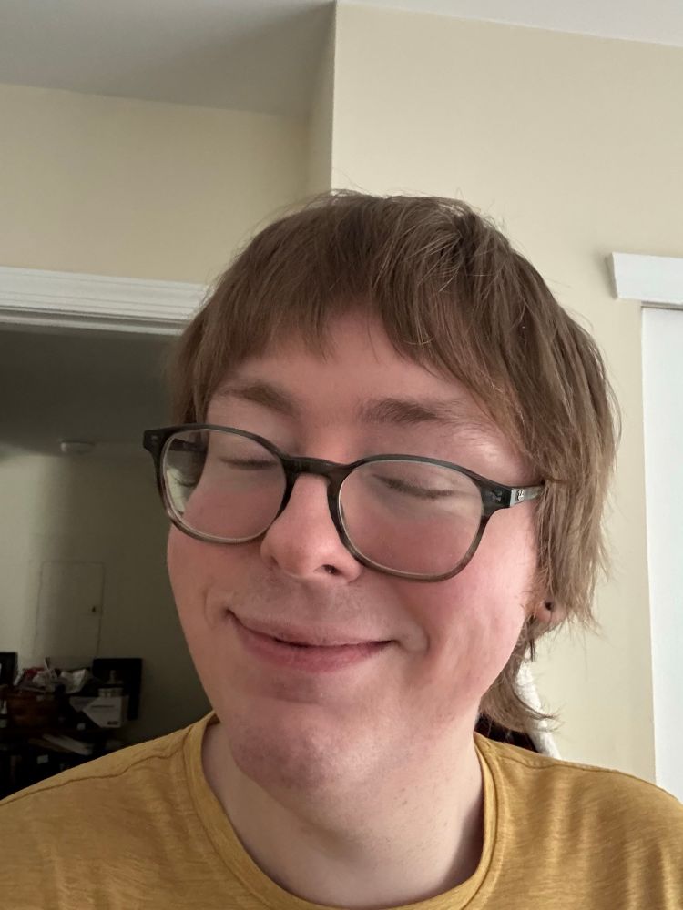 Person with a pleased close eyed smile showing off new haircut.

A semi wolf cut fringe type thing