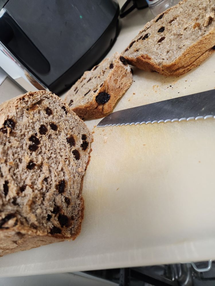 The raisin bread is now sliced, and glorious, if poorly arranged upon the cutting board. I was in too big a hurry to taste to take a good picture.