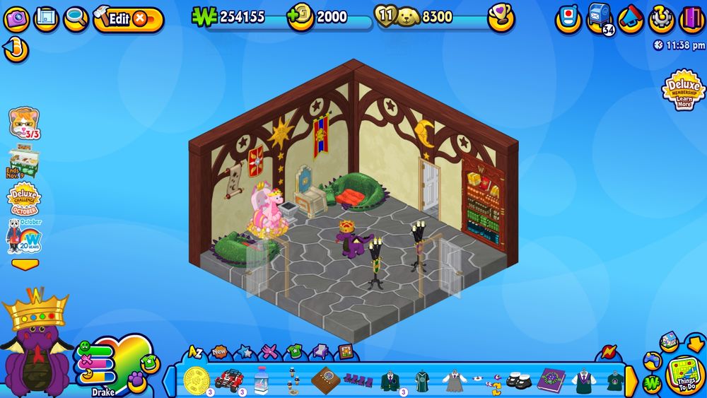 A screenshot of the game Webkinz, with a purple dragon wearing a golden crown selected as a pet. He is standing in a wizard-themed room with candelabras and two thrones. One of the thrones has a pink dragon sitting on it.