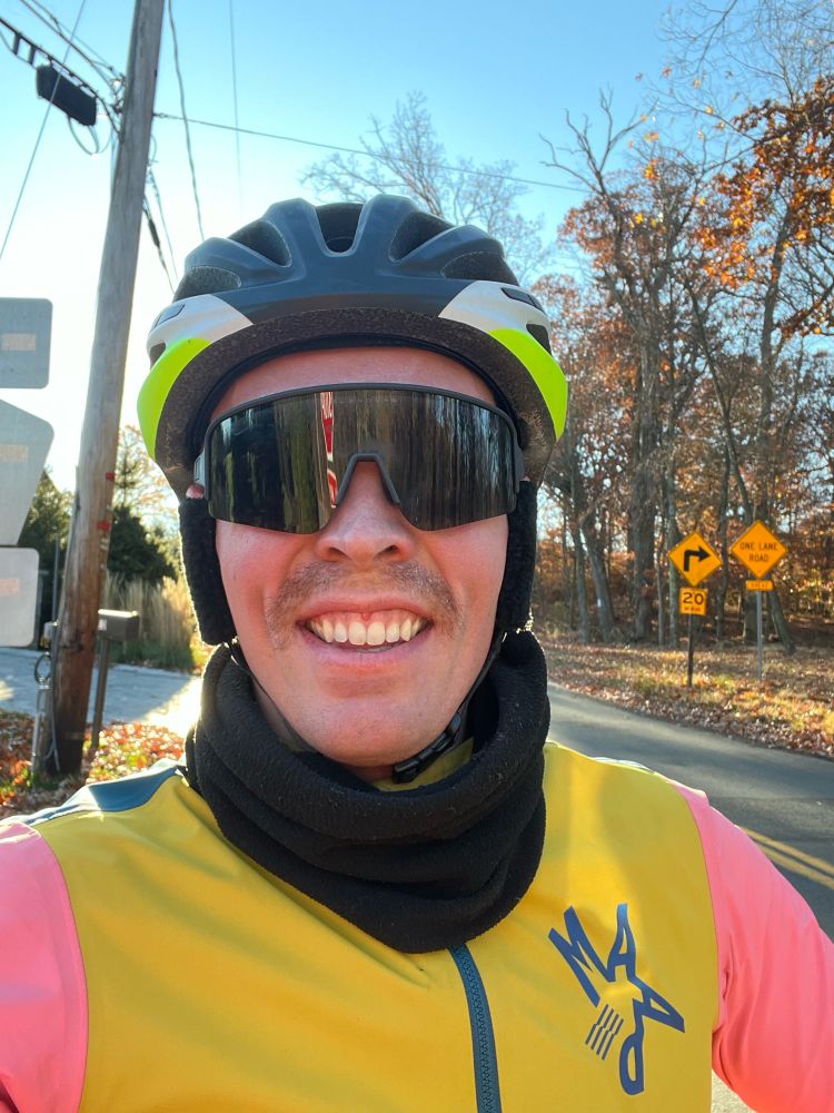 Cyclist in sunglasses smiling taking a selfie