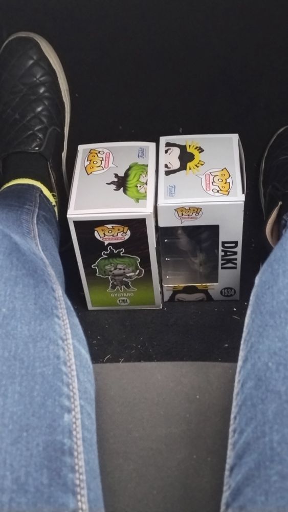 Gyutaro daki Funko pops freshly bought from GameStop still in the box sitting in front of the car seat