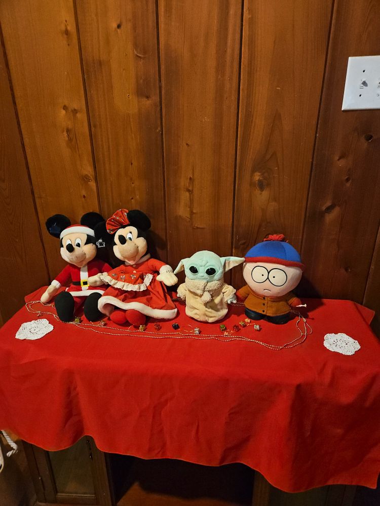 christmas stuffed animals on table with snowflake coasters