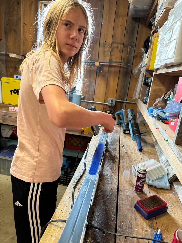 Waxing skis. All three are waxing skis. 