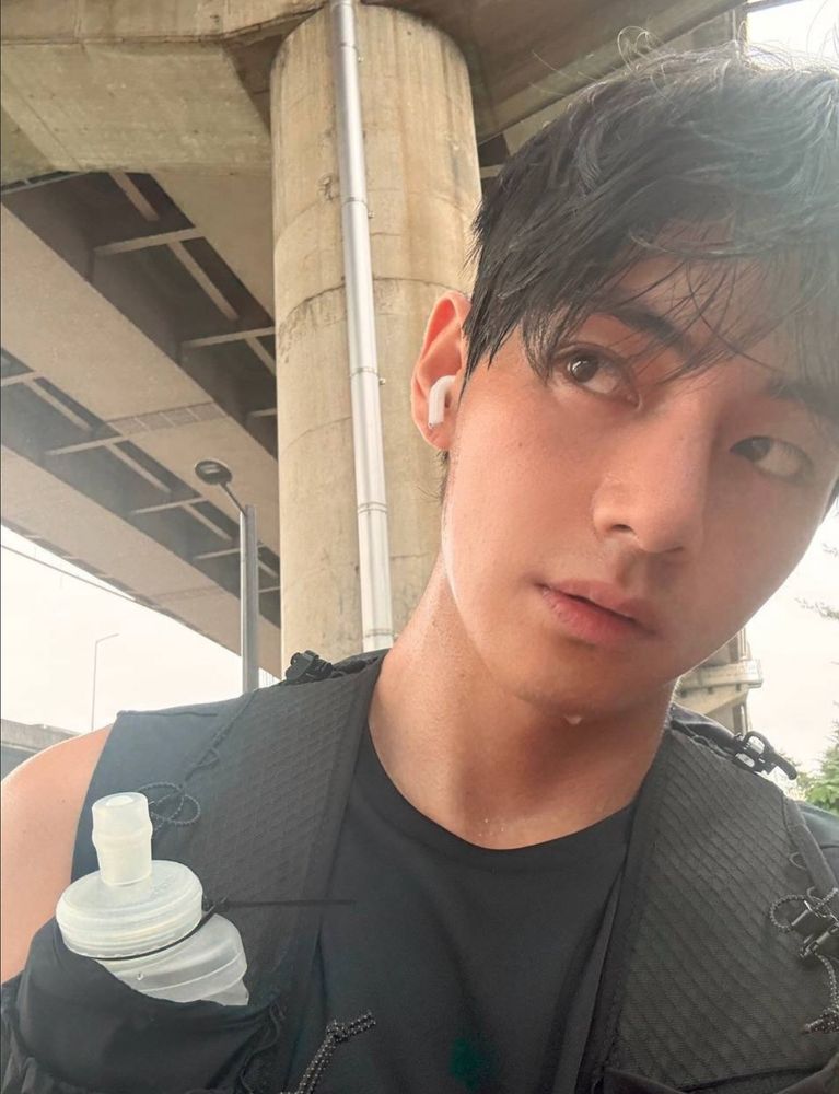 HE IS UNDER A BRIDGE LOOKING SWEATY AFTER A RUN IN HIS SPORTS VEST OR WHATEVER. MAKING PUPPY EYES AND SHIT