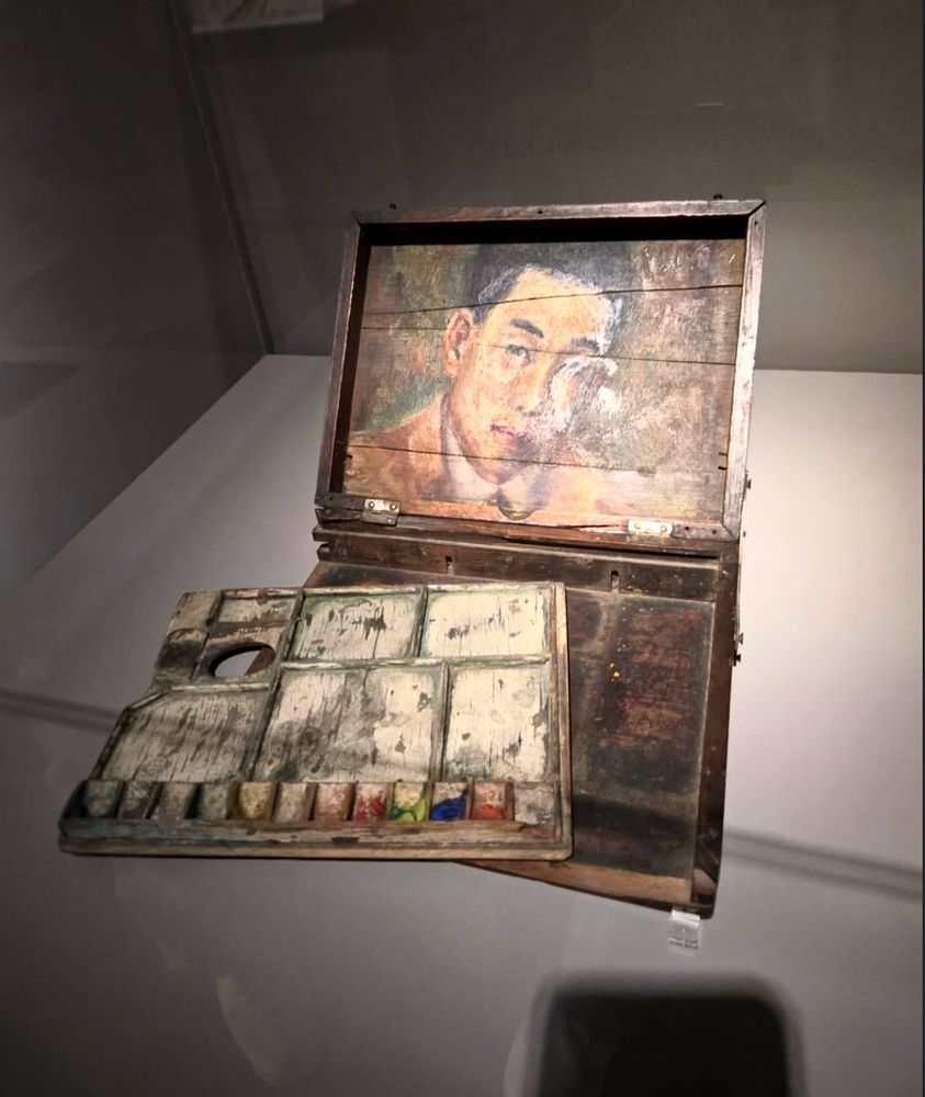 an old palette and paint box with a portrait of a man painted inside it