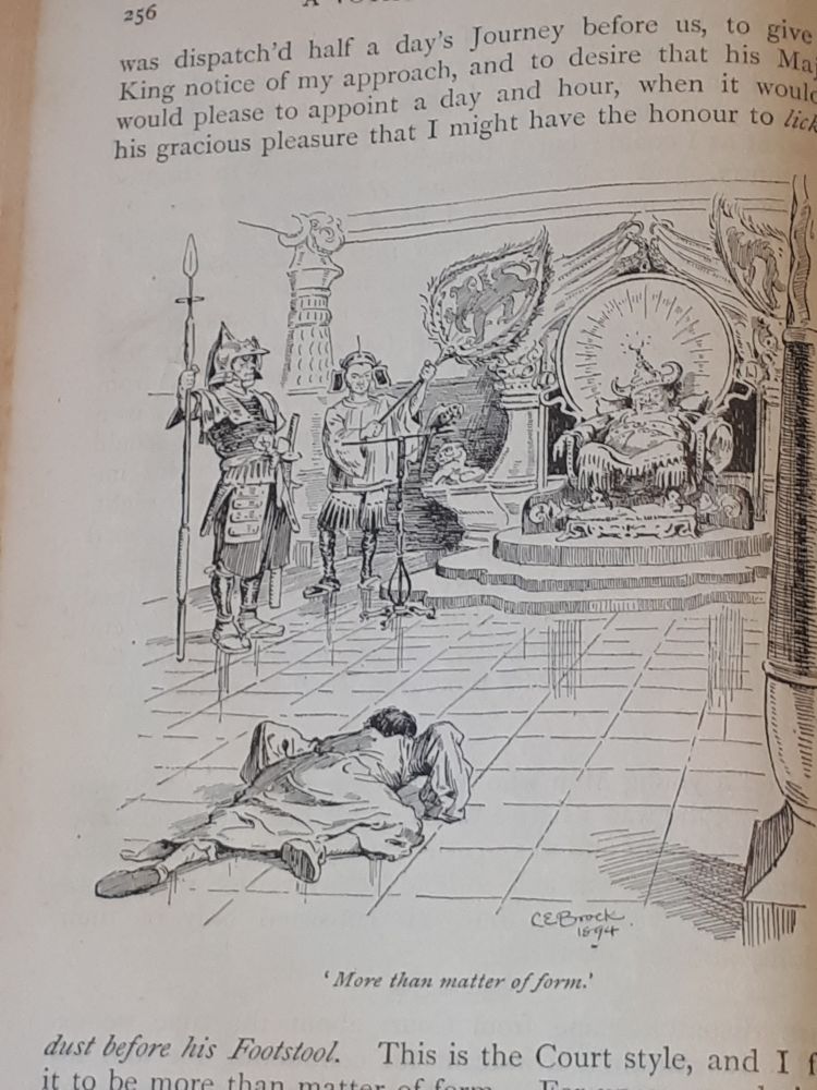 Man crawls across floor to an imperial figure lolling on a throne on a raised dais.
Text describes it 'having the honour to lick the dust before his footstool.'

(Gulliver's Voyage to Laputa etc. - Jonathon Swift. Image by C. E. Brock.)