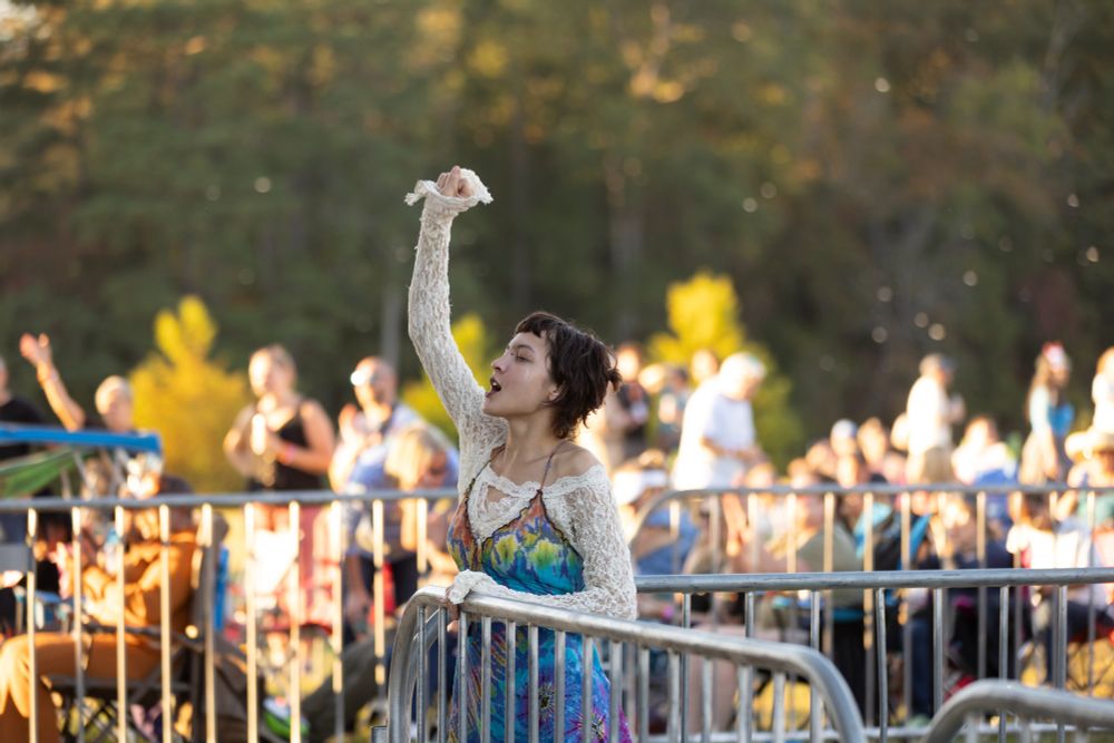 An excited audience member cheering along