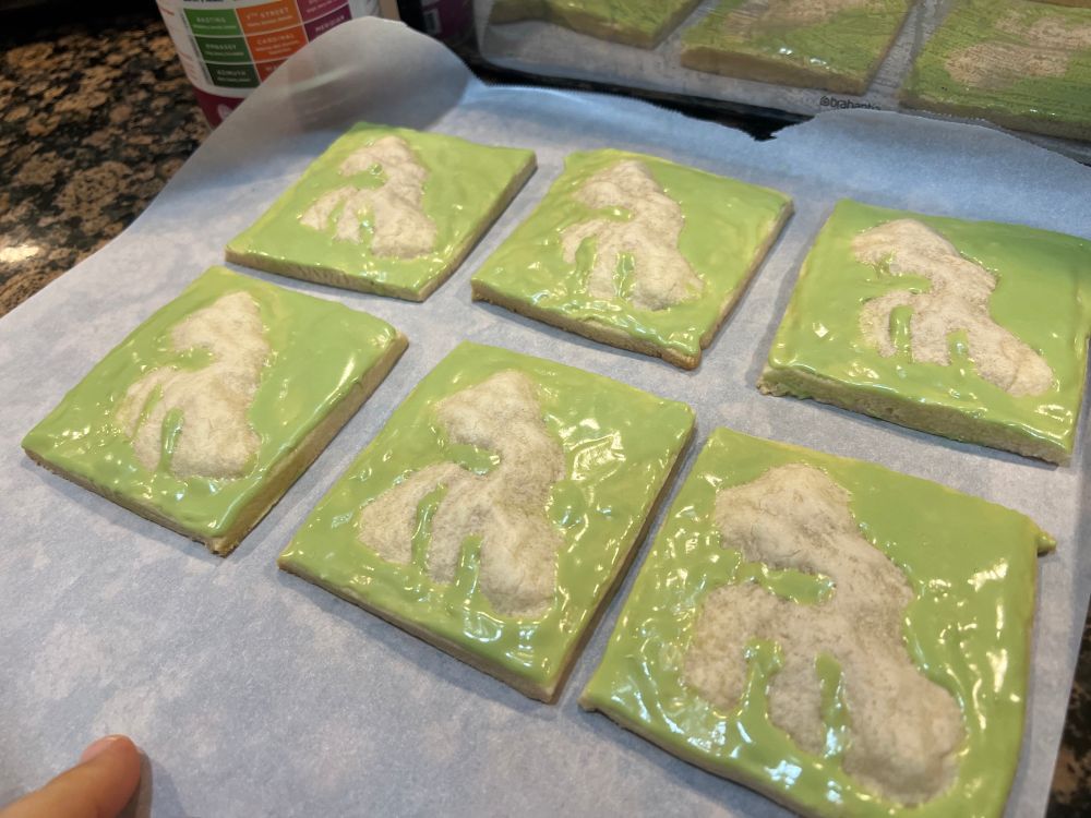 Photo of a lineup of 6 cookies that mostly look like green blobs! But are actually a topographic model! 