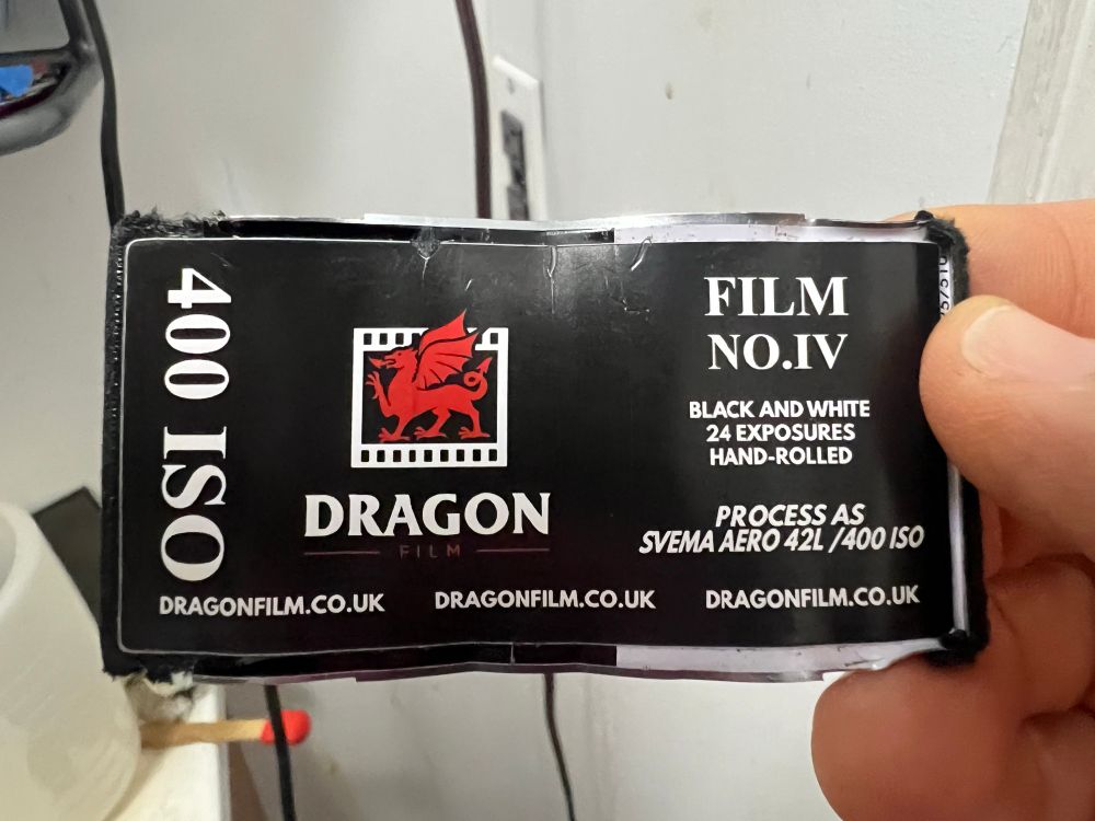 A flattened canister of Dragon no. IV film held in my hand. 