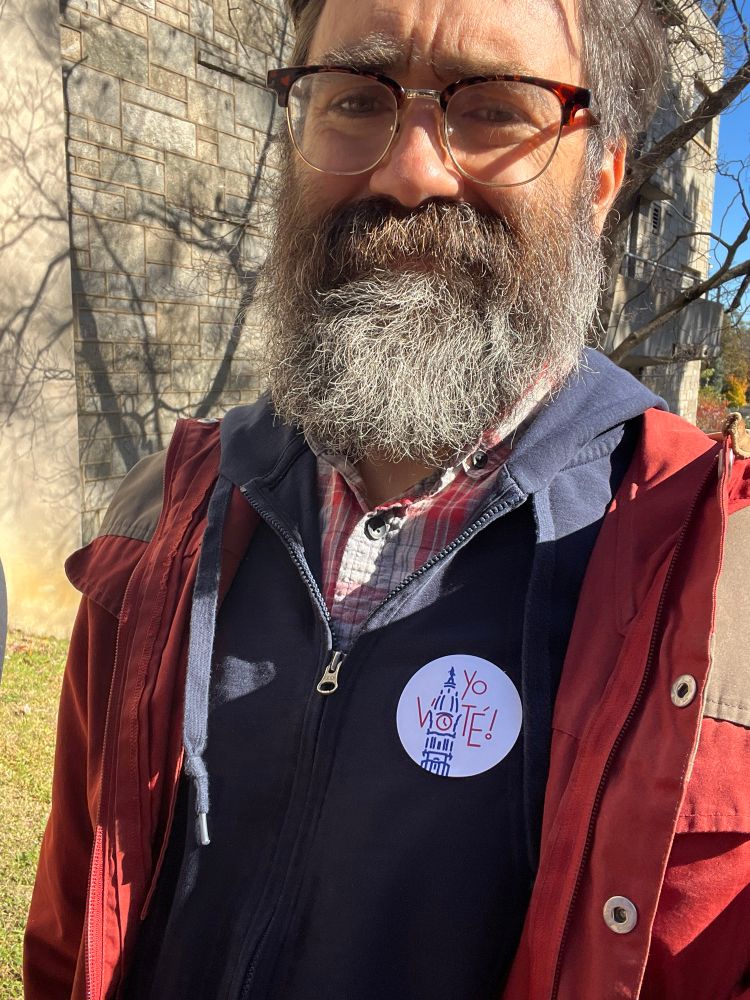 Selfie of a beardy man with a “yo vote” sticker. 
