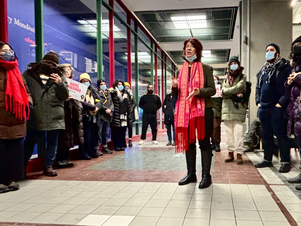 A photo of Rehab Nazzal speaking in front of a group of students, academics and artists about Concordia University's complicity in the genocide and Pip Day's unjust dismissal as Director of the Bina Ellen Art Gallery.