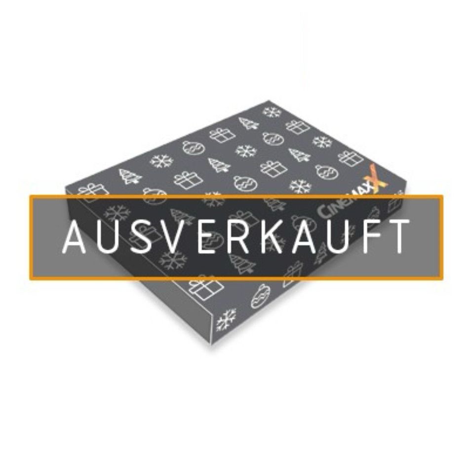 Das Bild zeigt eine graue Geschenkbox oder Verpackung mit einem weihnachtlichen Muster. Auf der Box sind kleine weiße Symbole zu sehen:

- Geschenkpakete
- Weihnachtsbäume
- Schneeflocken
- Weihnachtskugeln

Über der Box ist ein orangefarbener Balken mit der weißen Aufschrift "AUSVERKAUFT" platziert. Das CinemaxX-Logo ist ebenfalls auf der Box zu erkennen.