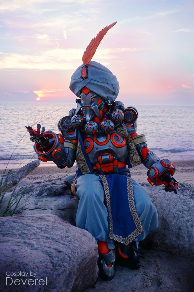 Ifrit Zenyatta cosplayer sitting in front of a purple hued sunset