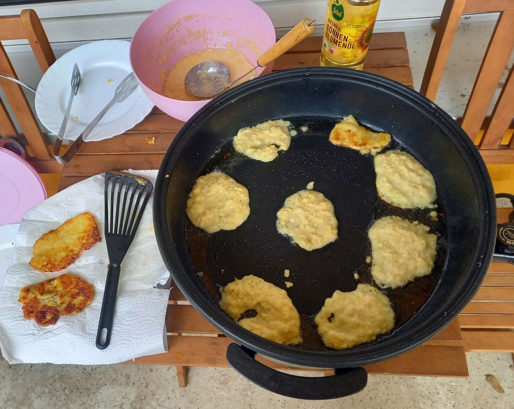 a large frying pan full of frying hash browns