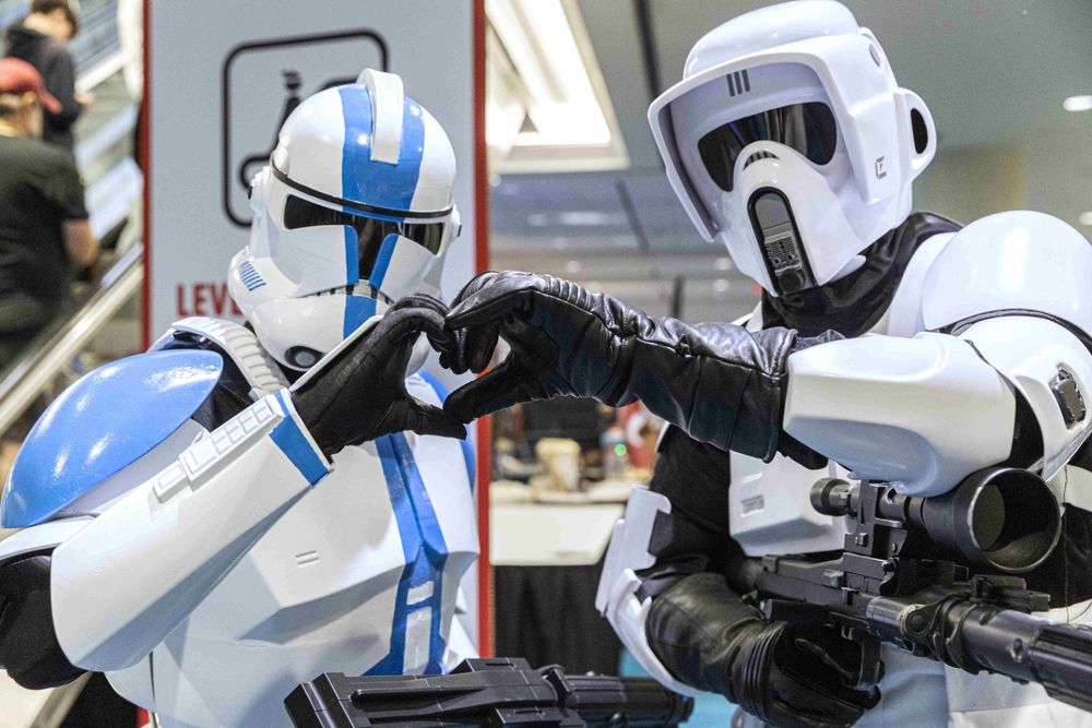 Two Stormtroopers holding their hands together in a heart shape. 