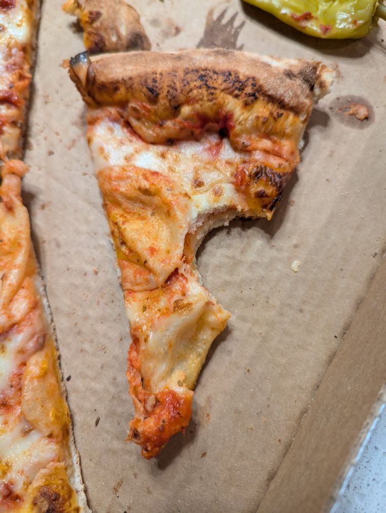 Pizza with a bite taken out of the side