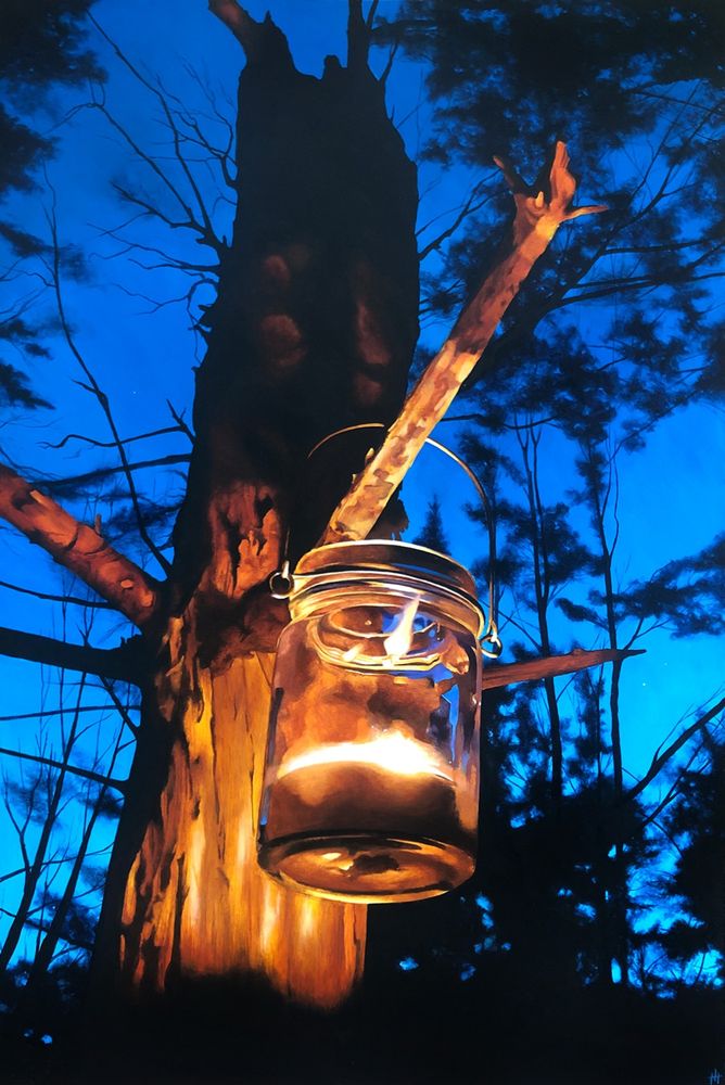 A night scene; a glass jar holding a candle hangs on the branch of a dead tree.