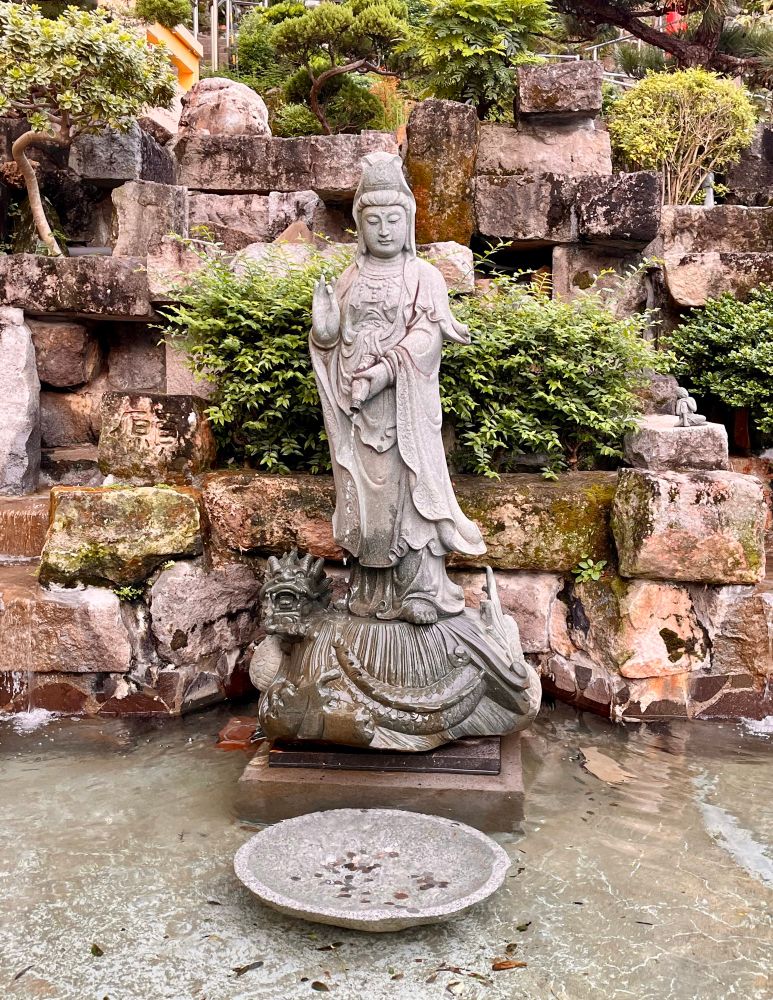 Avalokiteshvara / Kuan-Yin statue with pitcher and flowing water at Lin Ji Huogo temple Taipei.