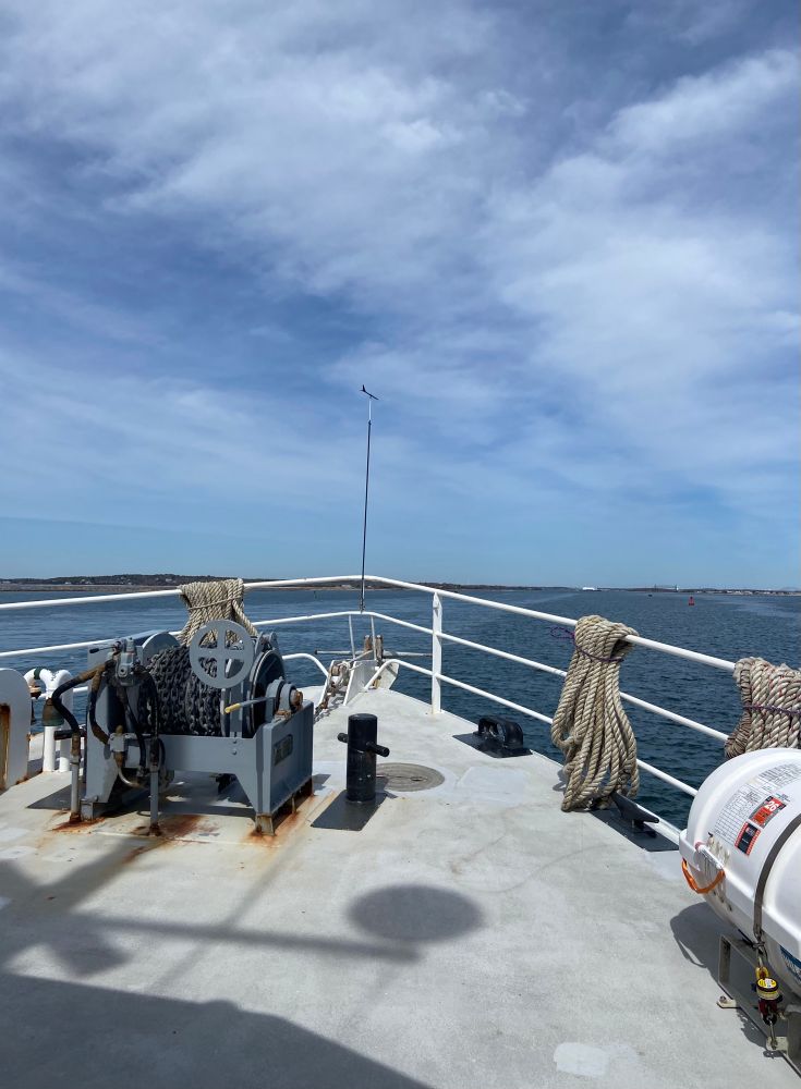 The bow of a research vessel with Cape Cod Canal in the distant background