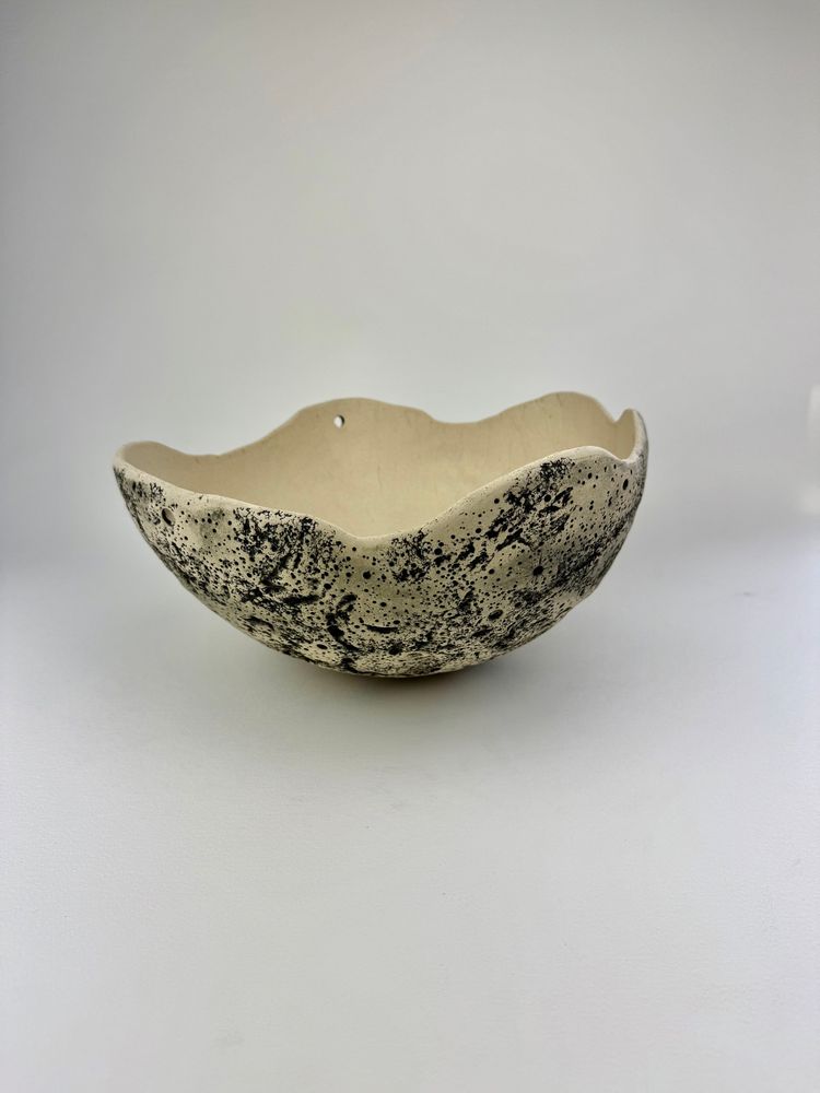 Artist is Karleigh Thompson of MoonMoon Ceramics. This is a bowl made of stoneware clay, with hand carved terrain detail, valleys, and craters. It was stained to give it the celestial look.