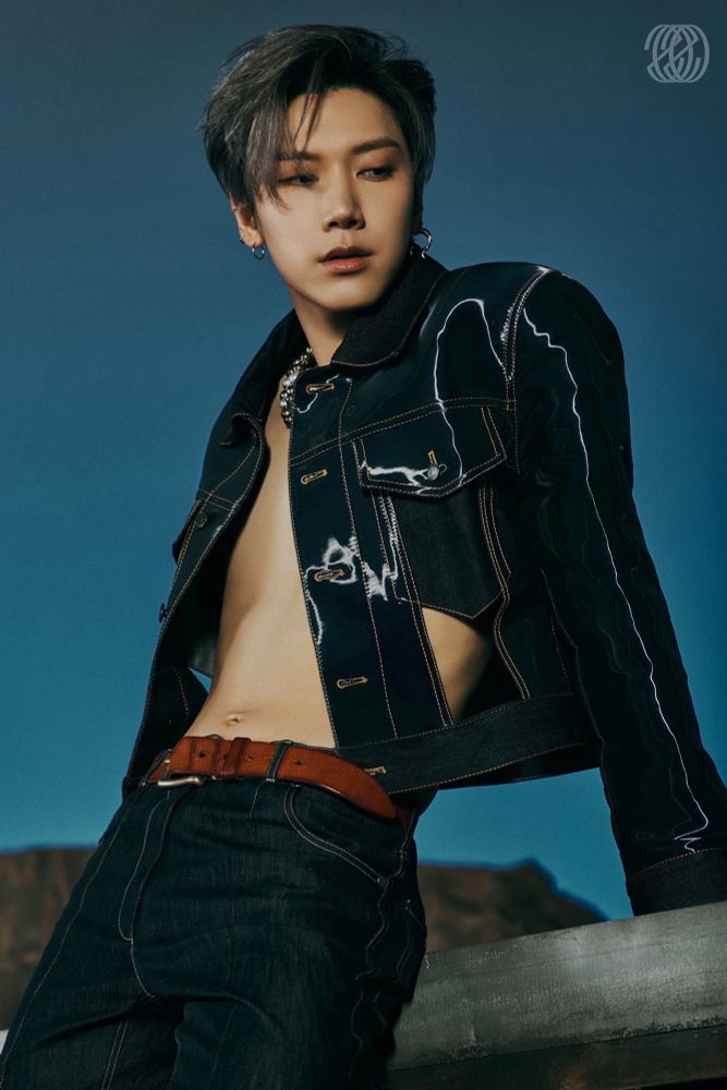 WayV Ten for NCT 2020 photo teasers. He’s wearing a dark blue jean jacket and jeans with no shirt underneath so you can get a glimpse of his torso and bellybutton (!!!) he’s leaning slightly backwards onto his hands 