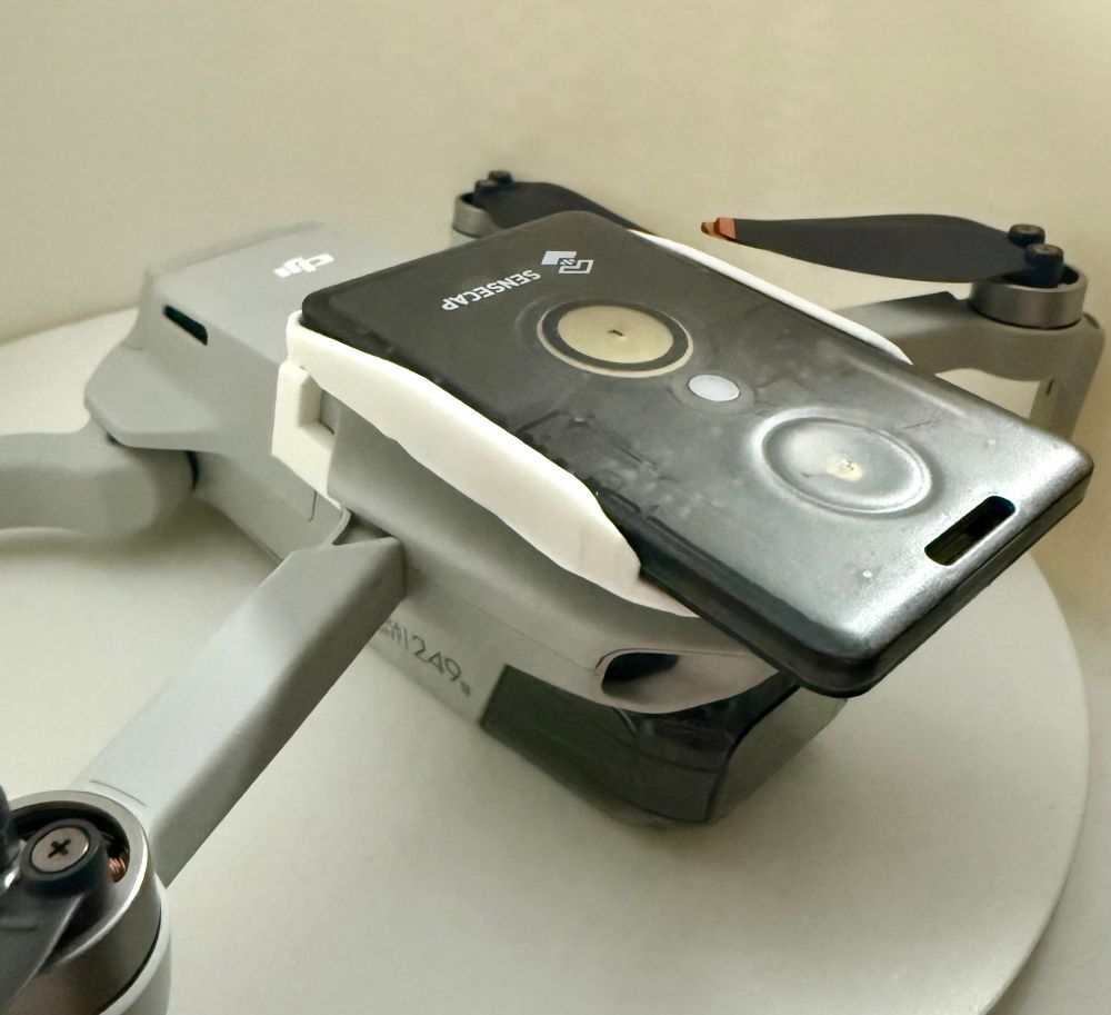 Picture of a 3d printed holder for a T1000-E on a DJI mini 2