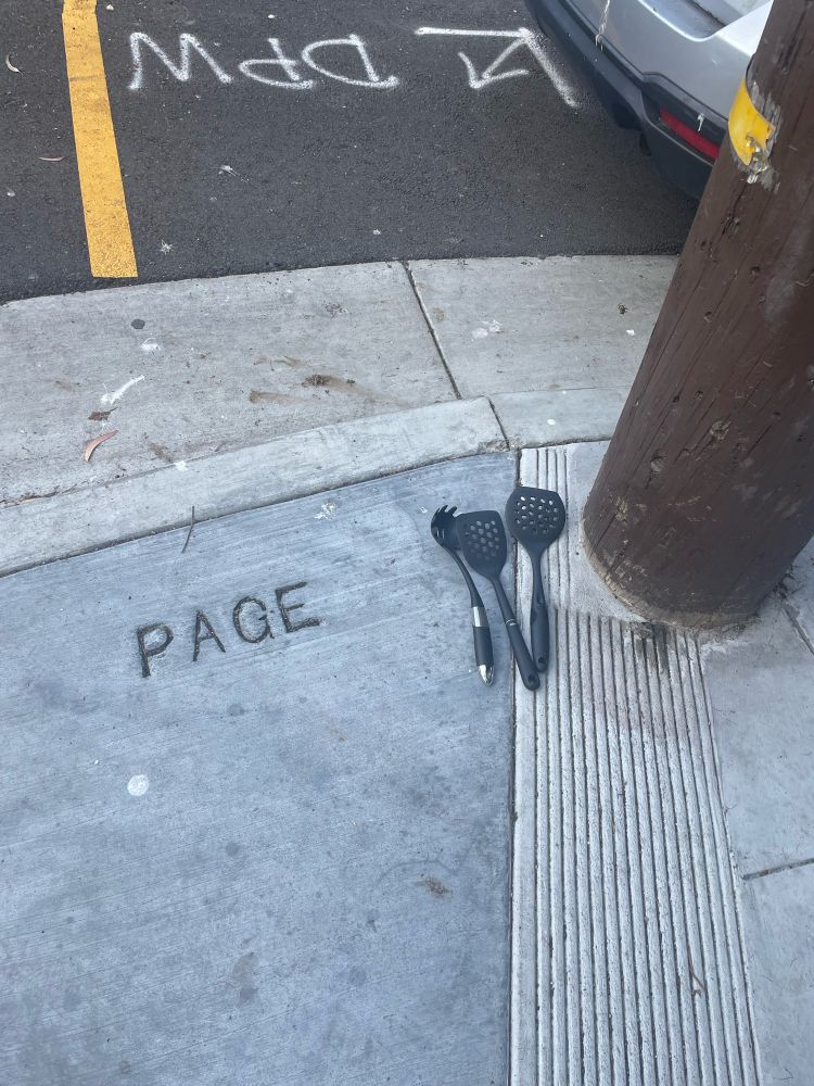 Black spatulas seen on the sidewalk of Page Street in San Francisco.