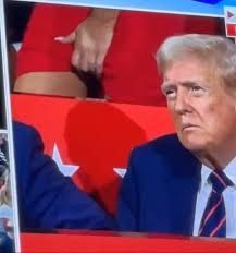 Guilfoyle scratching her crotch on camera behind Trump.