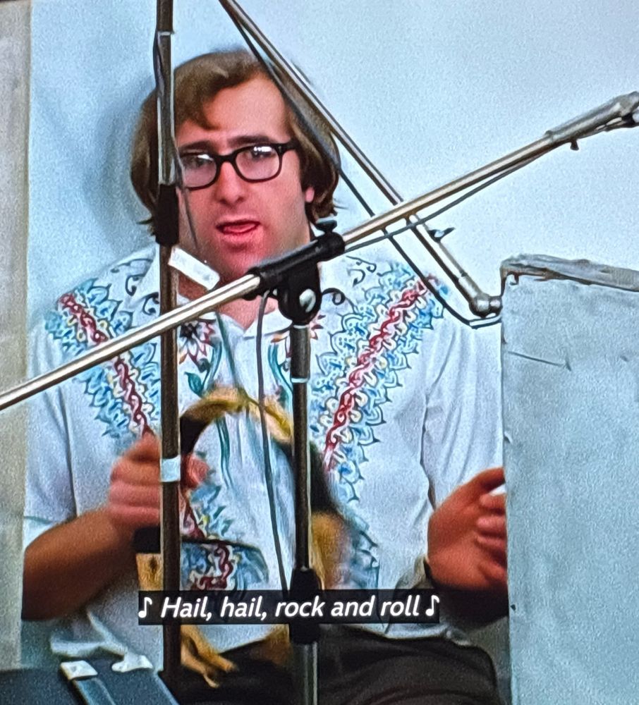 Mal Evans playing tambourine with a goofy expression on his face 