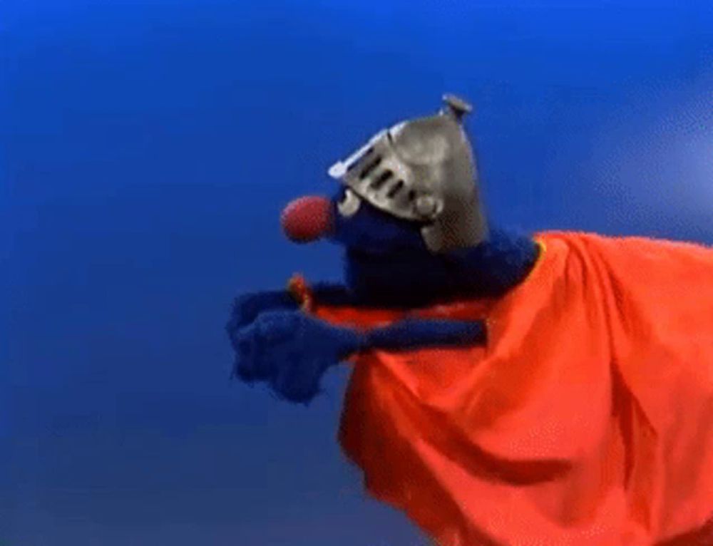 elmo from sesame street is wearing a helmet and cape