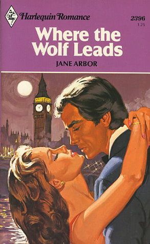A Harlequin Romance novel called "Where the Wolf Leads" by Jane Arbor. The cover art is a painting of two attractive white people almost kissing in the moonlight in front of Big Ben in London