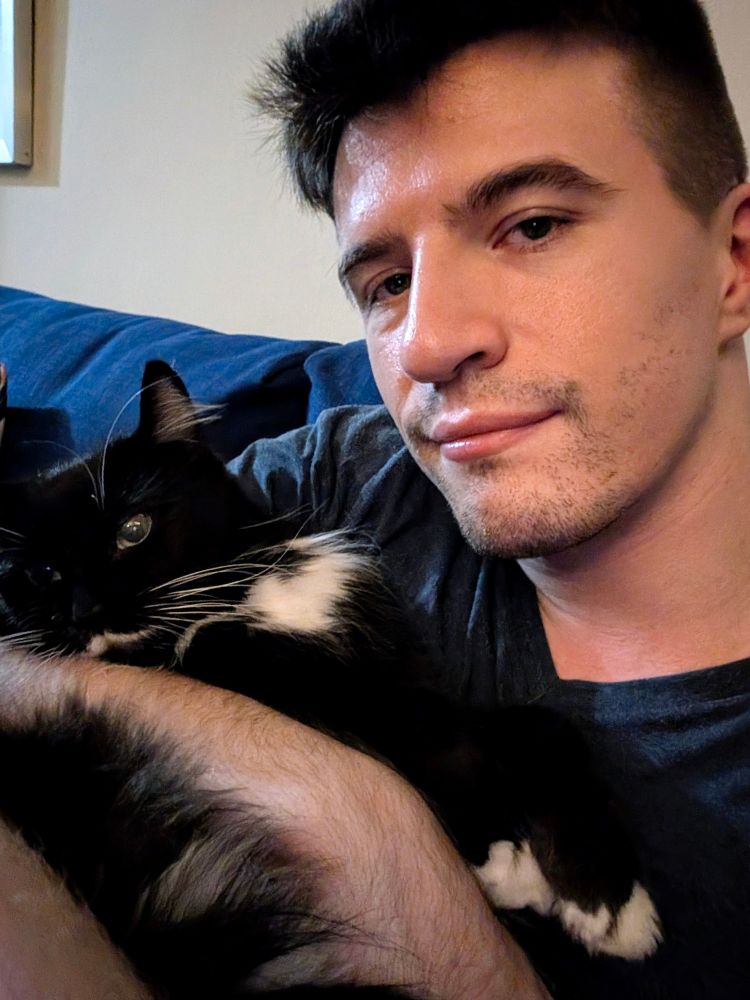 Me holding my cat while we were watching some TV