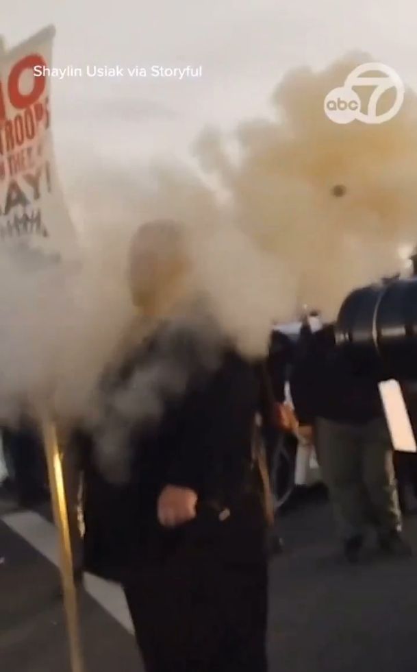 a screenshot still from the above video that shows the pepper ball (a distinctly spherical object) flying away in the puff of smoke