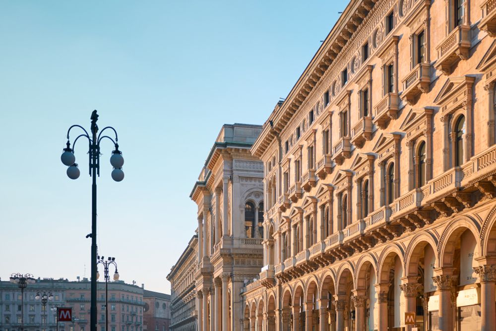 Milano city. Ornate building with arched windows and street lamp under a clear sky.