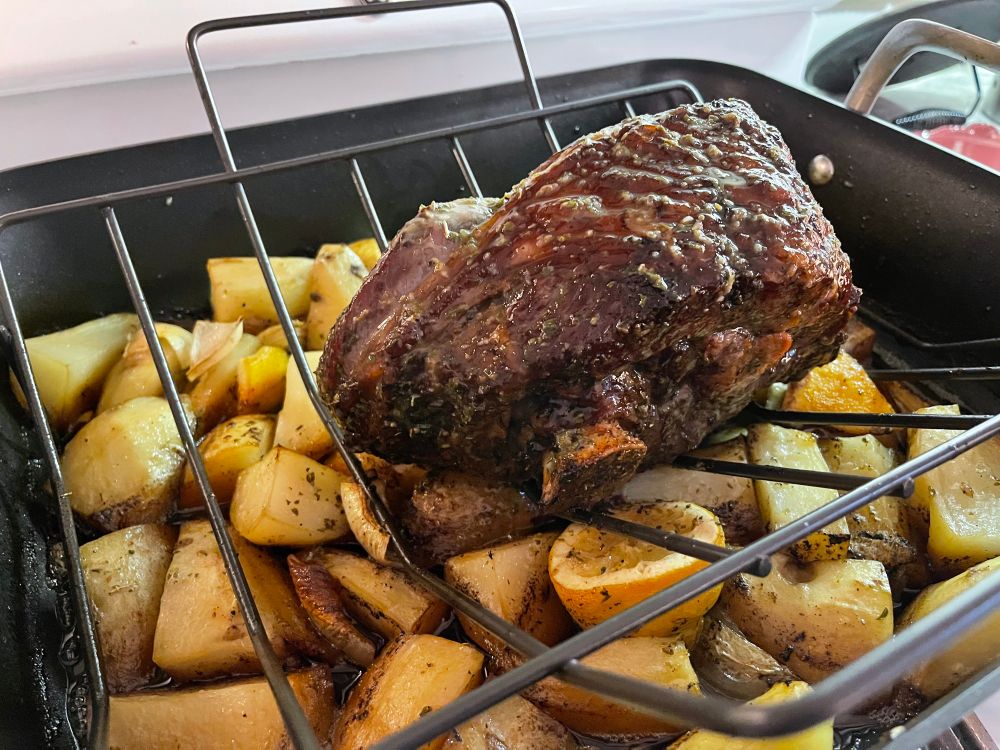 Stage 3: Final pan out of the oven, with browned lamb over a bed of potatoes, lemon and onions