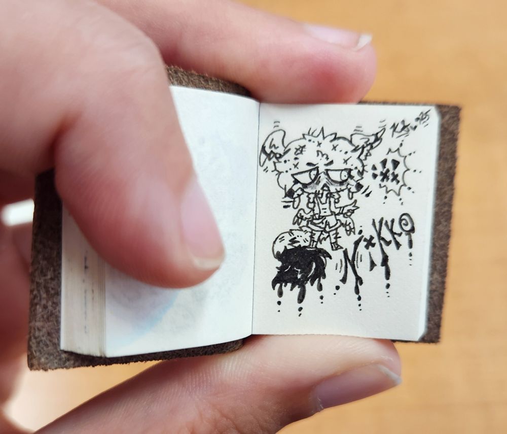 A tiny sketchbook featuring an artfight mini drawn attack! (micron only) ✏️ Character has dripping ink from their tail! Text on the page reads "Nikko".