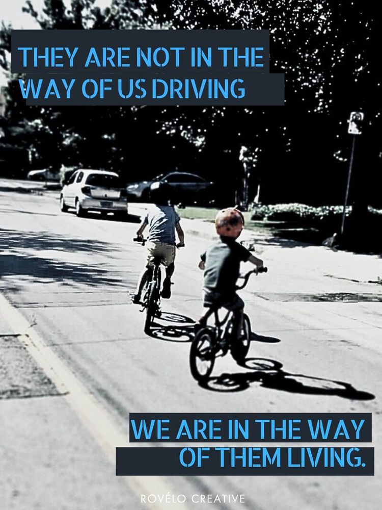 two kids biking on their street.
they are not in the way of us driving, we are the way of them living.