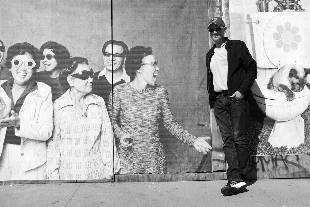 Michael Jang poses in front of The Jangs photo series wheat pasted mural over the boarded up GoodWill storefront, Richmond District, San Francisco, CA 2021

Photo by Jessica Chen