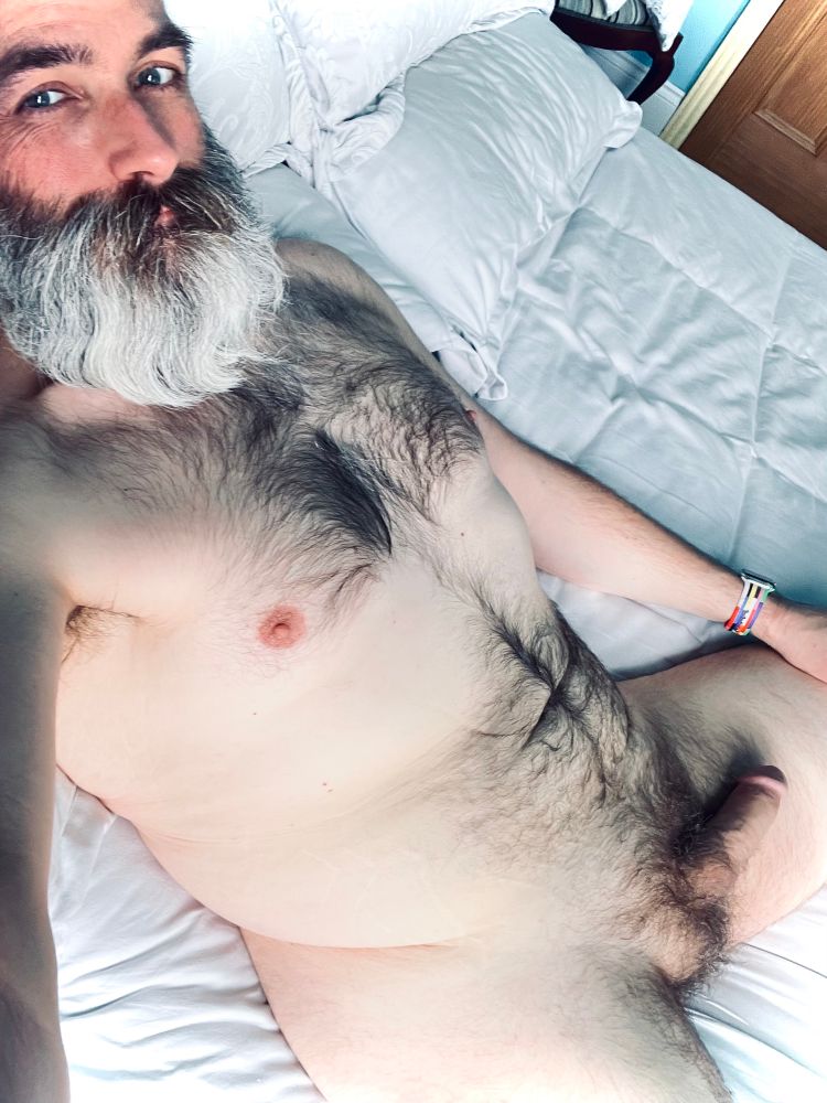 David laying naked on the bed as usual. His soft cock it’s flopped languidly on his left thigh. He’s looking to the camera with a wry smile