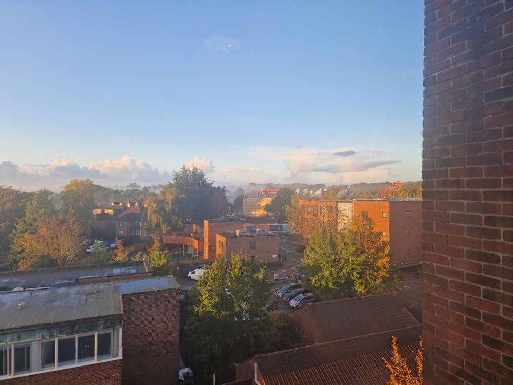 A view from the window showing a foggy sunrise