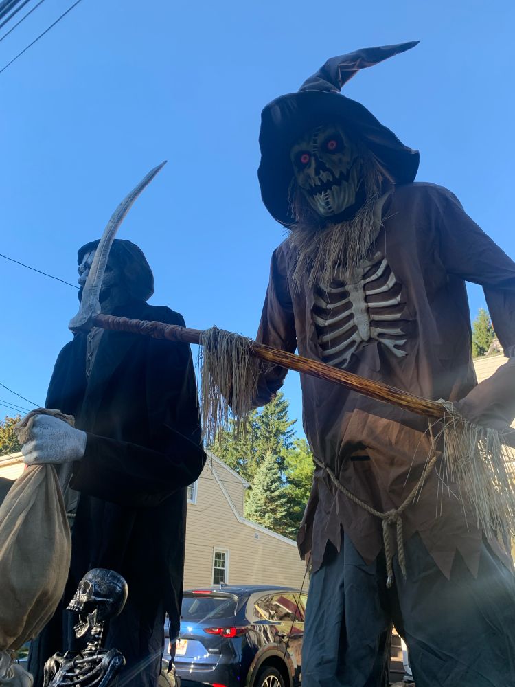 Scary 12 foot skeleton dressed up like scarecrow