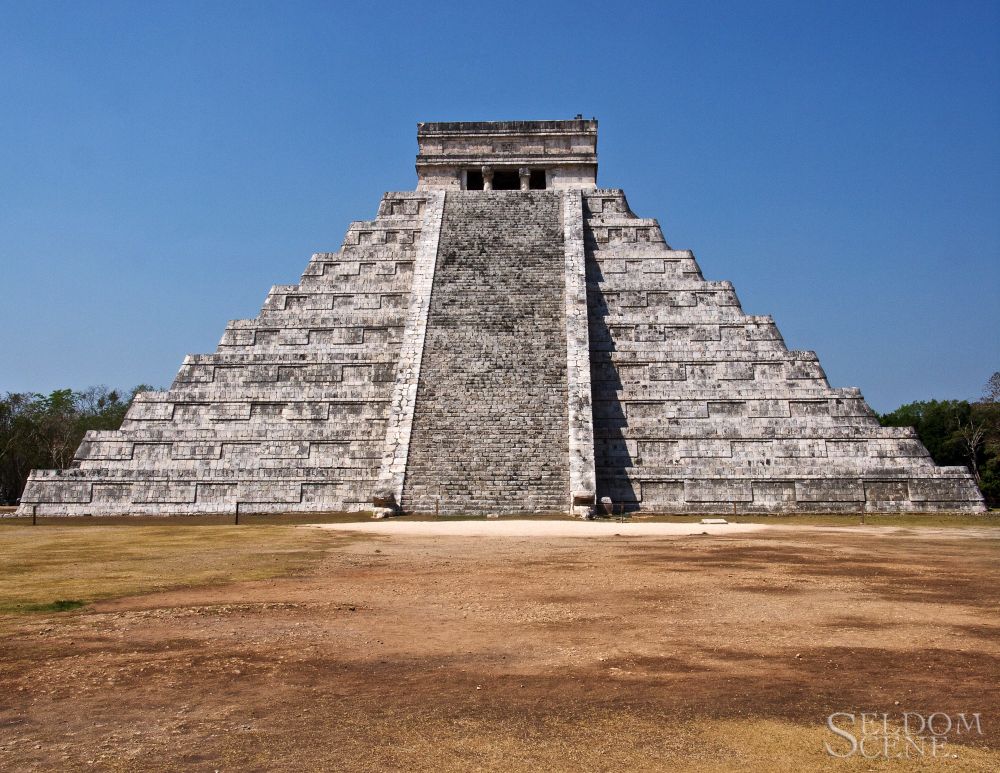 The restored north face of a late Maya stepped pyramid on a clear, sunny day. Sadly, it's no longer climbable by visitors.