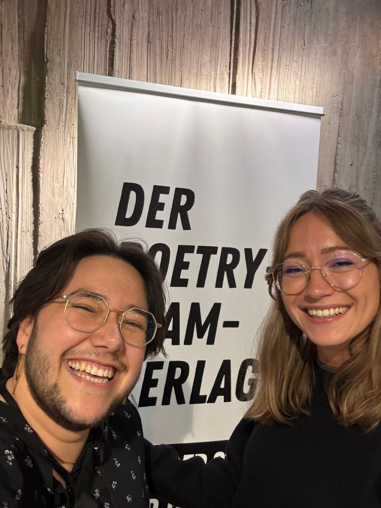Selfie of Denise Bretz and me in front of the official banner of the publisher Lektora