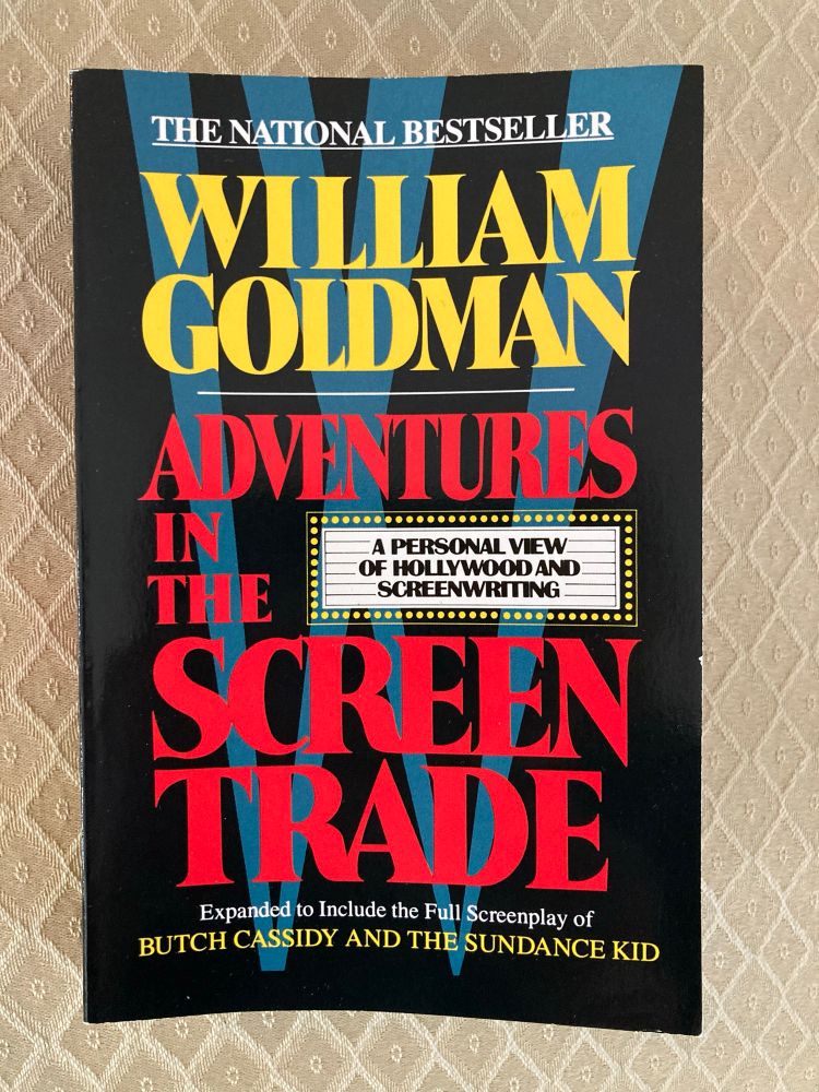 The cover of a paperback book with a dark blue background. The author name, William Goldman, appears at the top in yellow caps. The title, “Adventures in the Screen Trade,” appears below it in red caps.