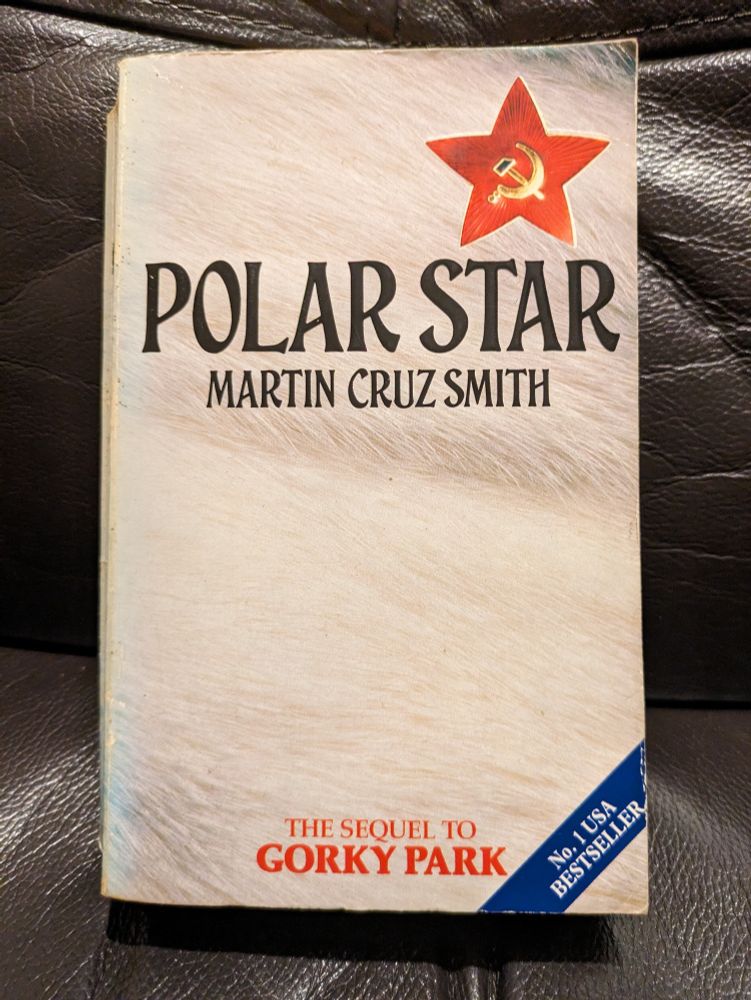 Cover of the book Polar Star by Martin Cruz Smith.Background is white, with black lettering and a gold hammer and sickle within a red star at the top right 