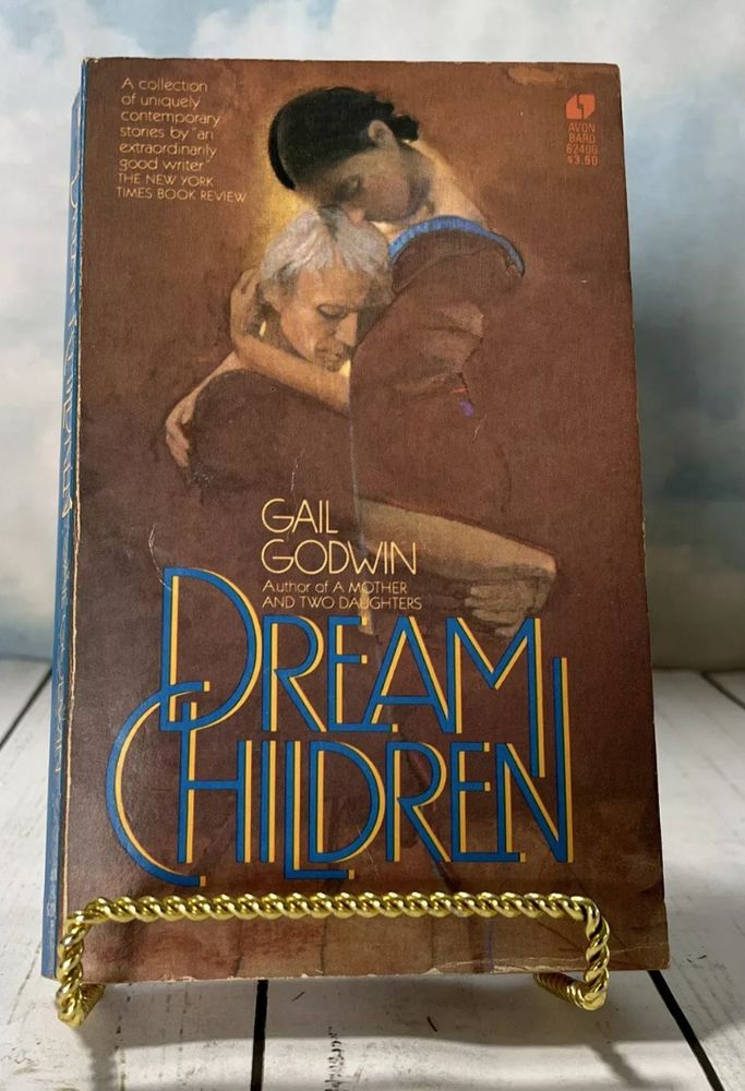 The book cover for Dream Children by Gail Godwin features an illustration of two figures embracing tenderly. One appears to be an older woman with silver hair, resting her head on the shoulder of a younger dark-haired woman. The background is a warm gradient of earthy tones, with a soft glow around the figures. The title “Dream Children” is written in bold blue and gold text at the bottom, with the author’s name above it. A tagline at the top describes the book as “A collection of uniquely contemporary stories by an extraordinarily good writer.”