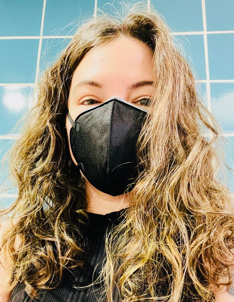 I'm wearing a black tank top, a black zimi air mask, and my long wavy brown is loose over my shoulders.
